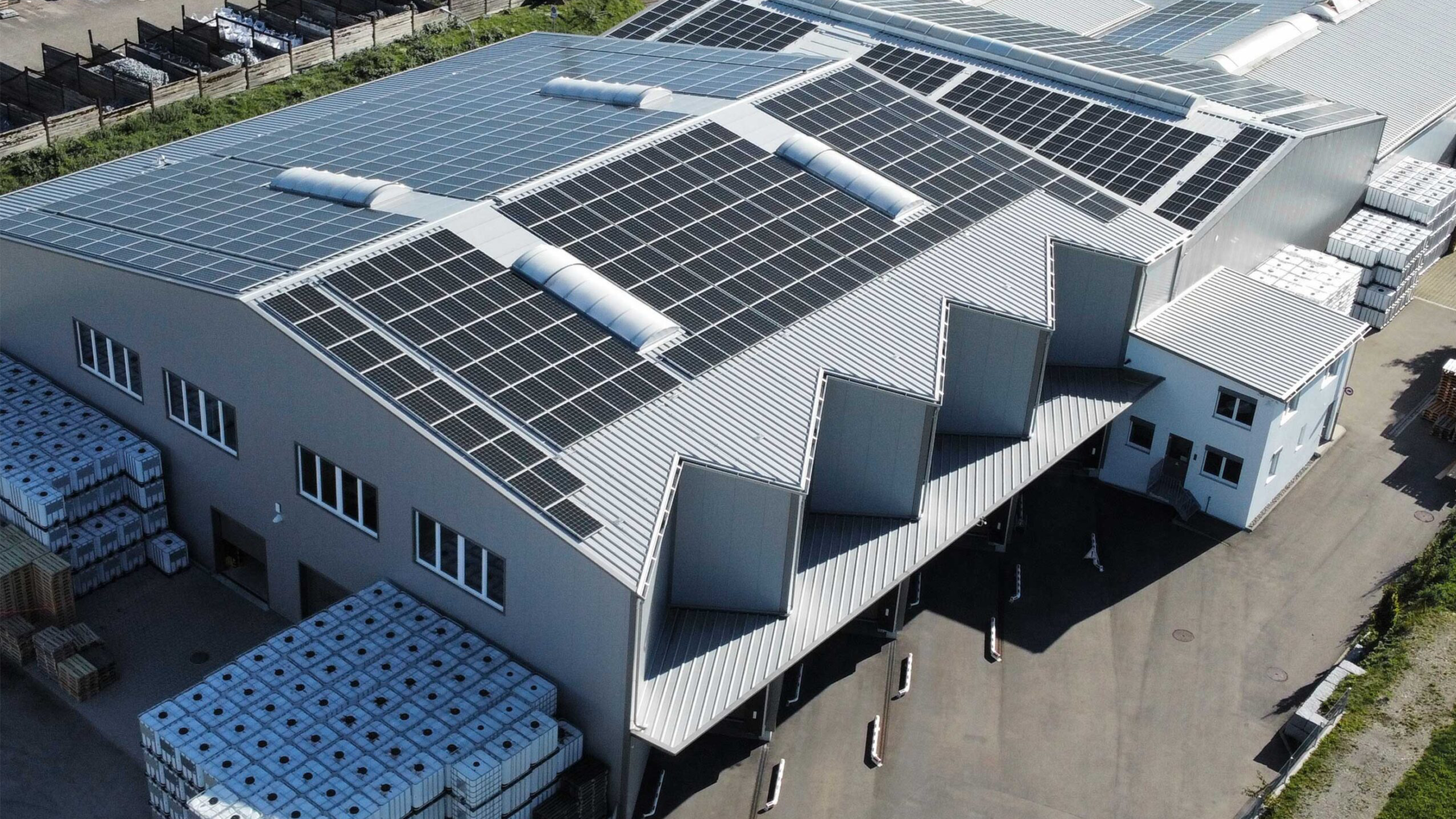 Aerial view of an industrial complex with solar panels