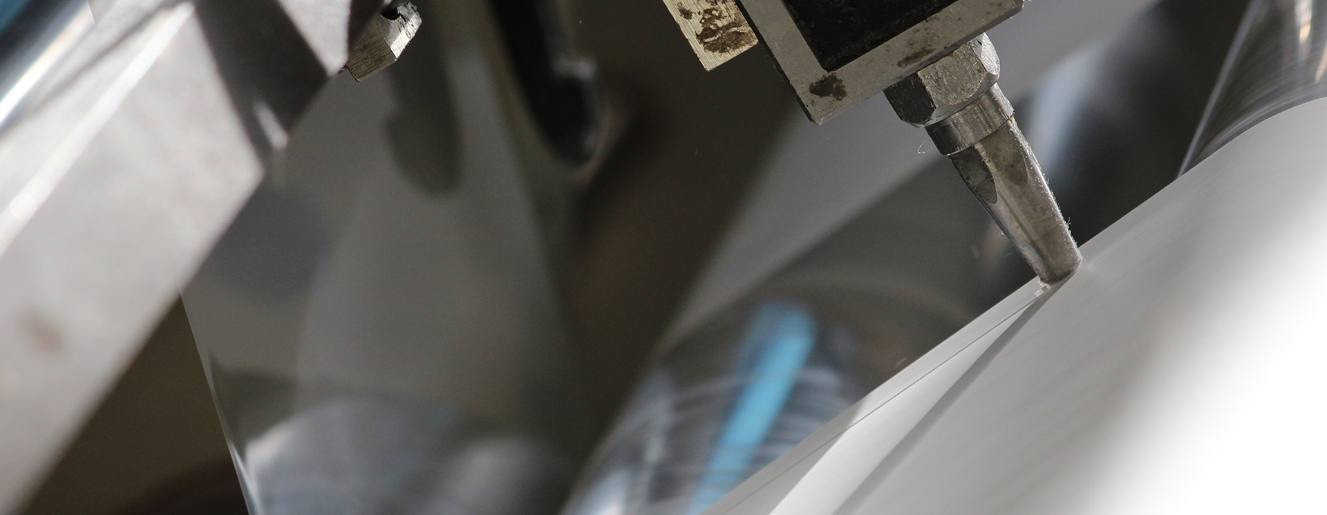 Close-up of a machine applying adhesive.